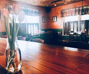 Sun reflecting on a vase of tulips sitting on the bar